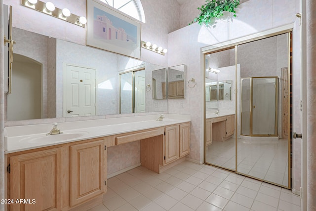 bathroom featuring tile patterned flooring, vanity, and walk in shower