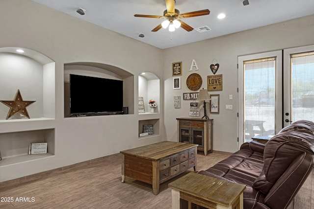 1008 E Mano Dr, New River, AZ 85087 - living room with built in shelves, ceiling fan, and light wood finished floors