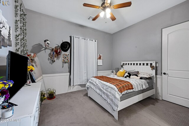 1008 E Mano Dr, New River, AZ 85087 - carpeted bedroom with wainscoting and ceiling fan
