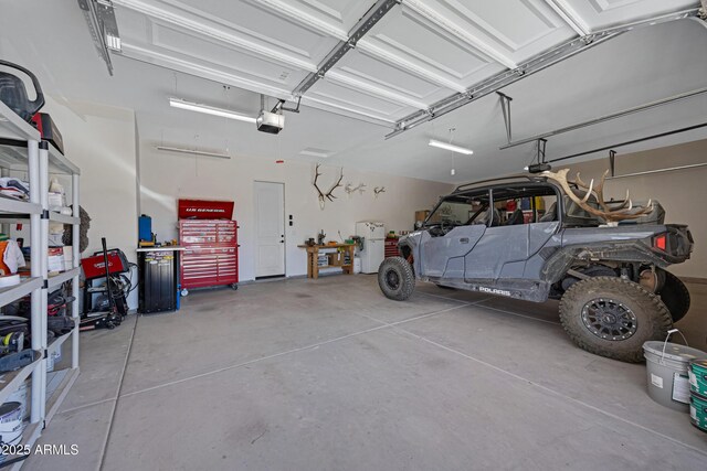 1008 E Mano Dr, New River, AZ 85087 - garage featuring a garage door opener and a workshop area