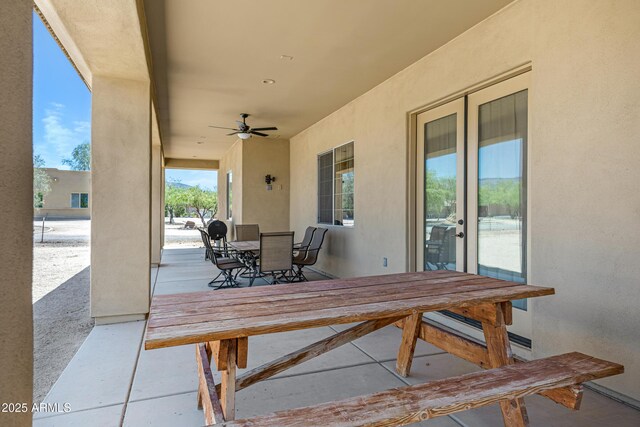 1008 E Mano Dr, New River, AZ 85087 - deck featuring outdoor dining space, ceiling fan, a patio, and a baseboard radiator