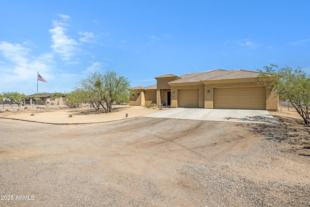 1008 E Mano Dr, New River, AZ 85087 - view of front of home featuring stucco siding, concrete driveway, and a garage