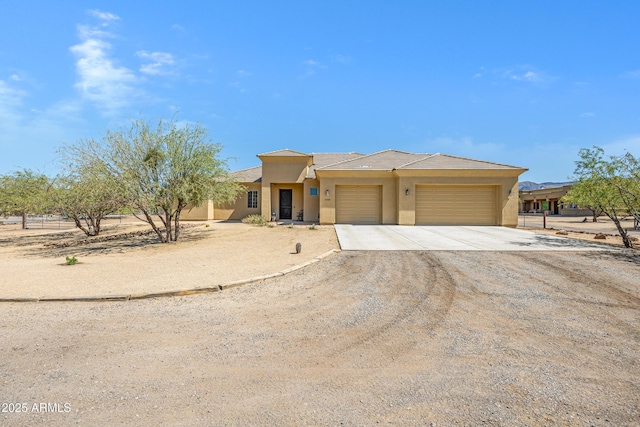 1008 E Mano Dr, New River, AZ 85087 - view of front of house with stucco siding, driveway, and an attached garage