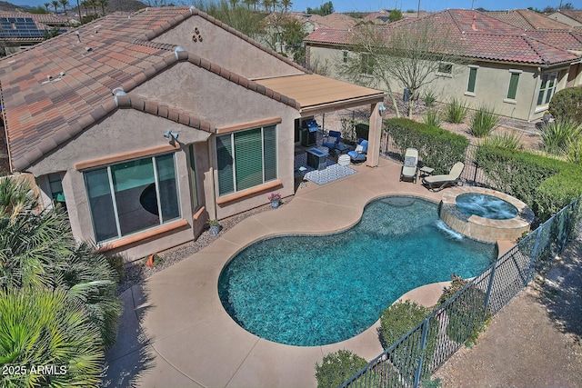 view of pool with a pool with connected hot tub, a fenced backyard, and a patio