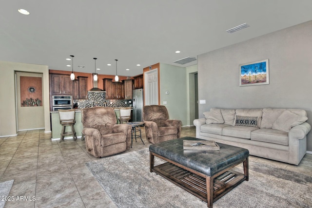 living room featuring light tile patterned floors, baseboards, visible vents, and recessed lighting