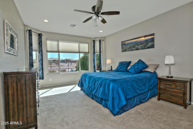 carpeted bedroom with a ceiling fan, visible vents, and recessed lighting