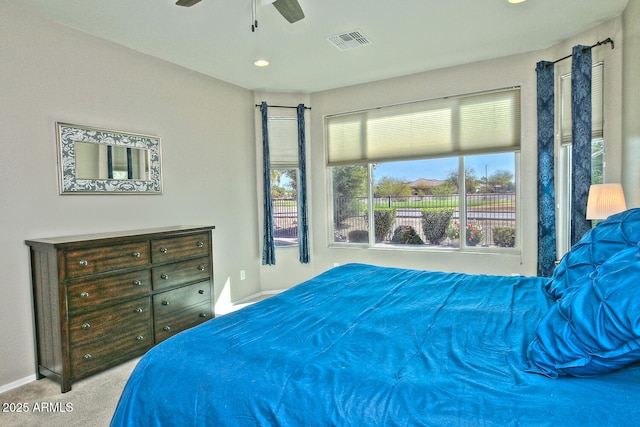 carpeted bedroom with ceiling fan, visible vents, and baseboards