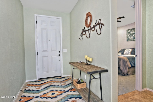 tiled entryway featuring baseboards