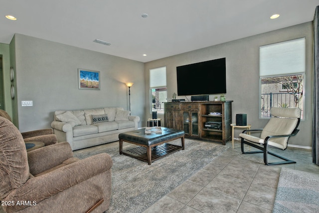 living area featuring baseboards, light tile patterned flooring, visible vents, and recessed lighting