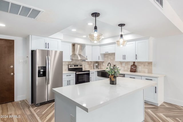 kitchen with white cabinets, wall chimney exhaust hood, decorative backsplash, and stainless steel appliances