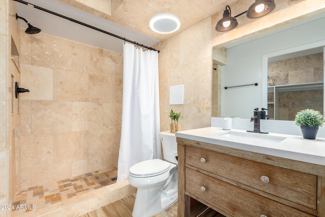 bathroom featuring hardwood / wood-style floors, vanity, a shower with shower curtain, toilet, and tile walls