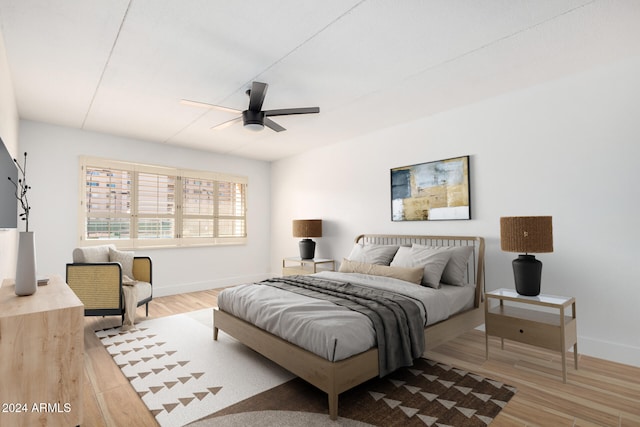 bedroom with light hardwood / wood-style floors and ceiling fan