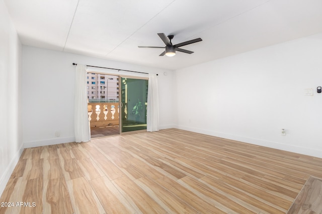 empty room with ceiling fan and light wood-type flooring