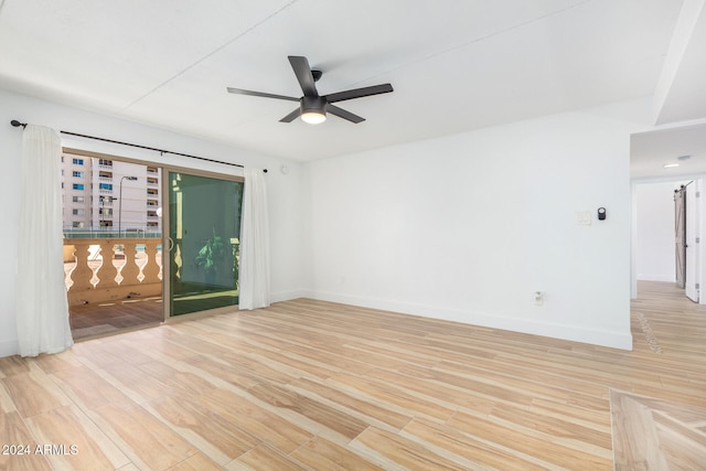 spare room with light wood-type flooring and ceiling fan