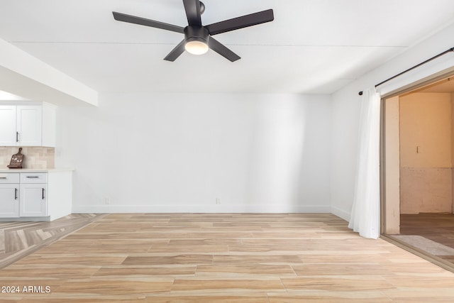 spare room with ceiling fan and light hardwood / wood-style flooring