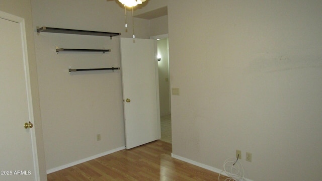 unfurnished bedroom featuring light wood-style flooring and baseboards