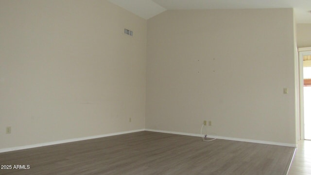 spare room featuring visible vents, lofted ceiling, baseboards, and light wood finished floors
