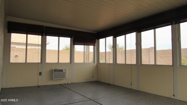 unfurnished sunroom featuring an AC wall unit