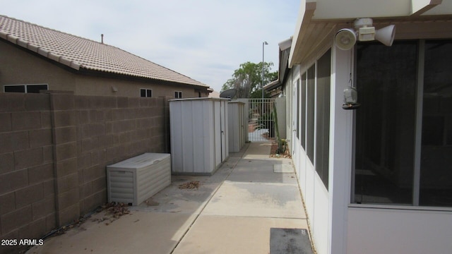view of side of property featuring a gate and fence