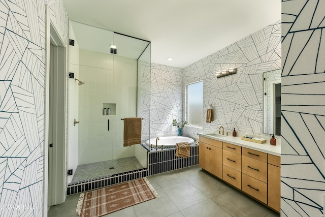 bathroom featuring tile walls, tile patterned flooring, vanity, and separate shower and tub