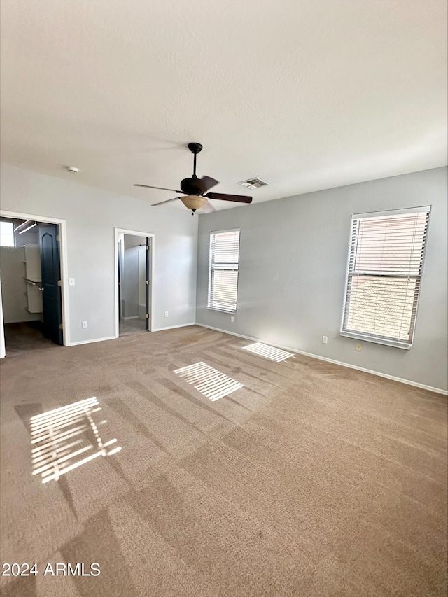 unfurnished room featuring carpet and ceiling fan