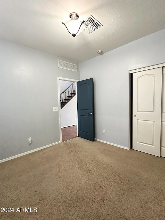 unfurnished room featuring carpet flooring