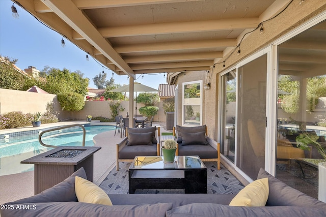 view of patio / terrace with a fenced backyard, a fenced in pool, and an outdoor living space with a fire pit