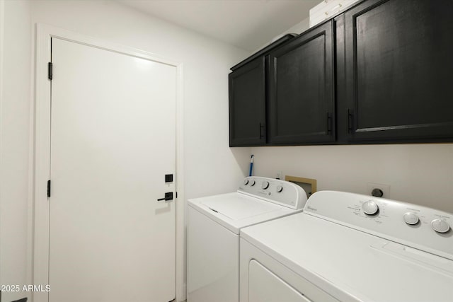 washroom featuring cabinet space and independent washer and dryer