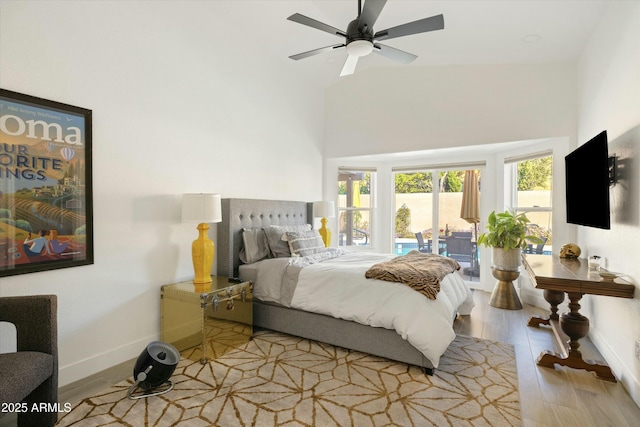 bedroom featuring light wood-style floors, access to outside, baseboards, and ceiling fan