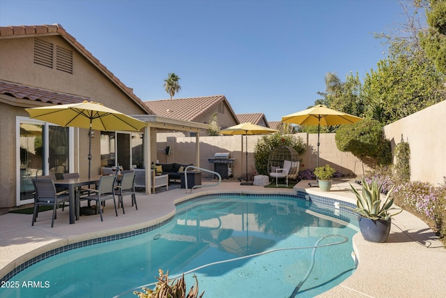 view of pool featuring a fenced backyard, a grill, a fenced in pool, and a patio