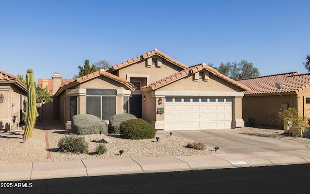 mediterranean / spanish-style house with a garage, a tile roof, concrete driveway, and stucco siding