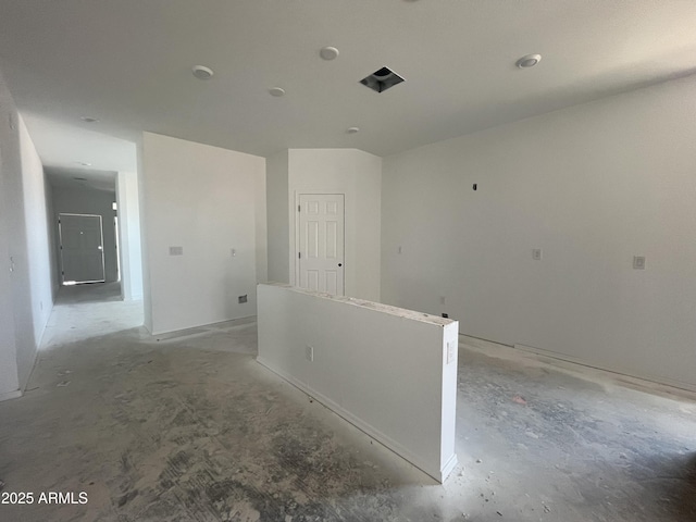hall featuring concrete flooring