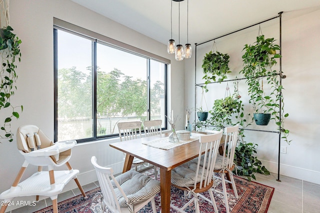 tiled dining area with a chandelier