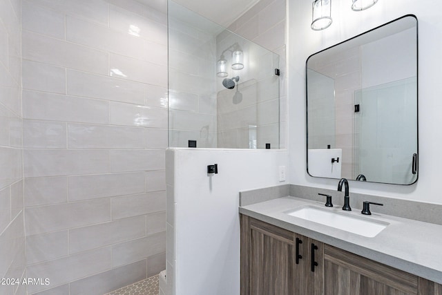 bathroom featuring vanity and tiled shower