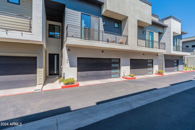 view of front of house with a balcony and a garage