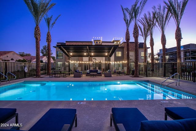 pool at dusk featuring a patio