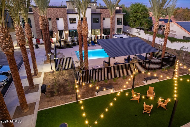 pool at dusk featuring a patio