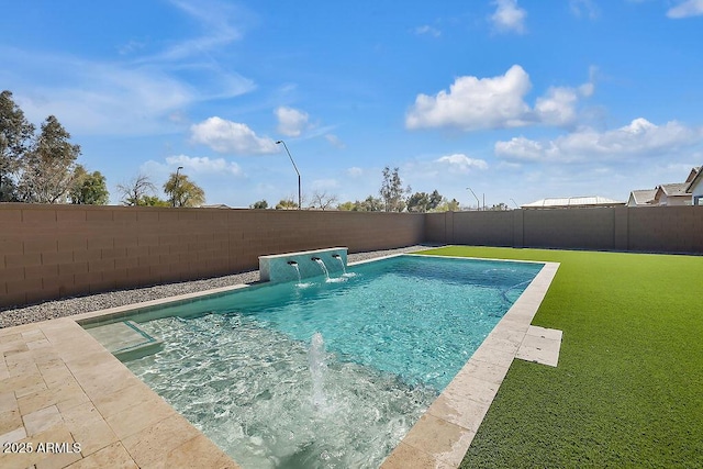 view of swimming pool with a lawn and a fenced backyard