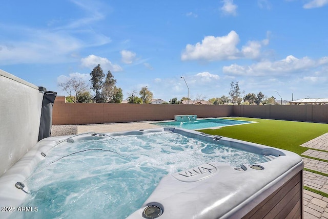 view of pool with a hot tub and a fenced backyard