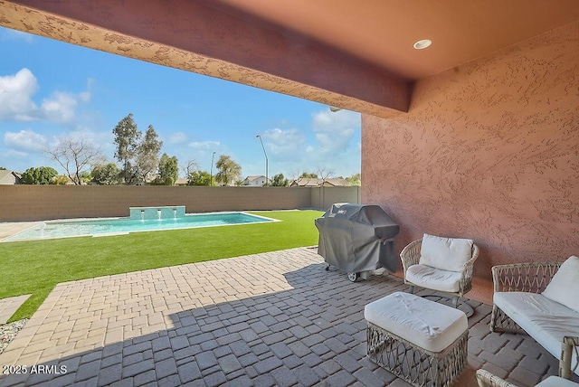 view of patio with a fenced in pool, a fenced backyard, and a grill