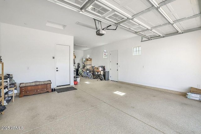 garage featuring a garage door opener and baseboards