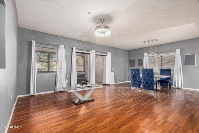 workout area featuring dark hardwood / wood-style flooring and a notable chandelier