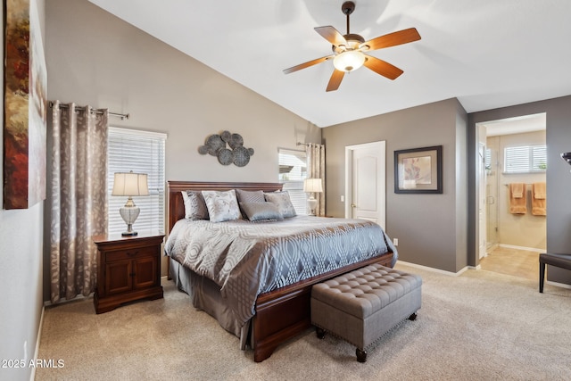 carpeted bedroom featuring connected bathroom, vaulted ceiling, and ceiling fan