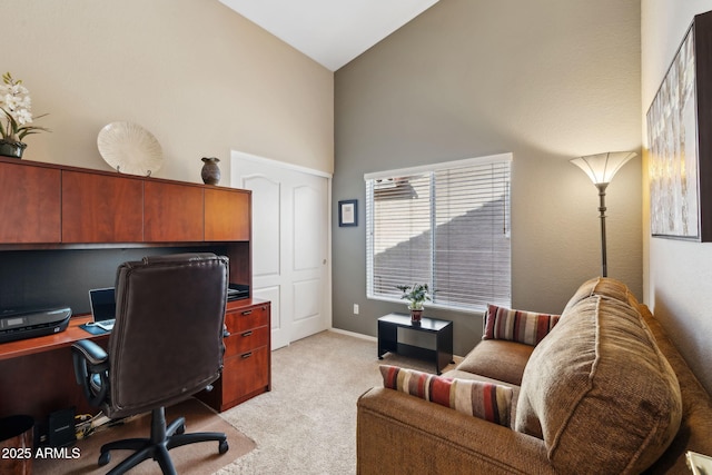 office space featuring light colored carpet and high vaulted ceiling