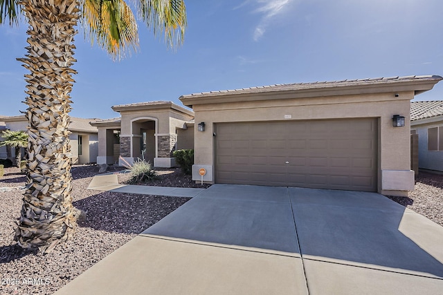 view of front of property with a garage, driveway, a tiled roof, and stucco siding