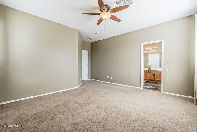 unfurnished bedroom featuring visible vents, connected bathroom, light carpet, and baseboards