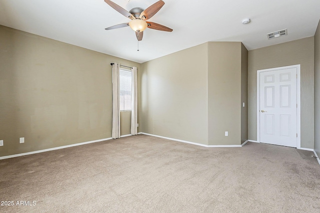 empty room with a ceiling fan, carpet, visible vents, and baseboards