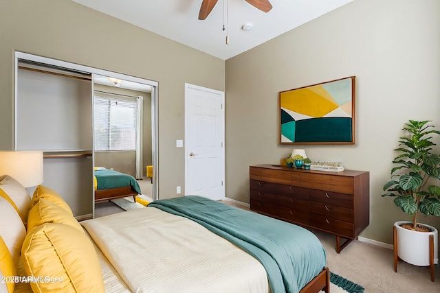 bedroom featuring light carpet, ceiling fan, and baseboards