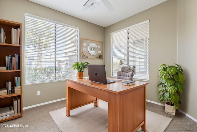 carpeted home office featuring ceiling fan, visible vents, and baseboards