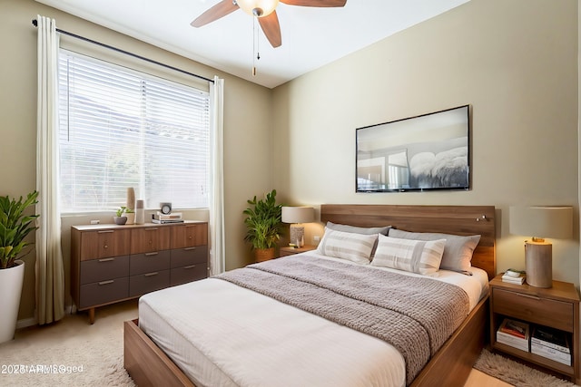 bedroom with light carpet and ceiling fan